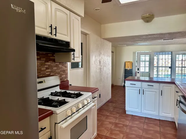 a kitchen with a stove and a sink