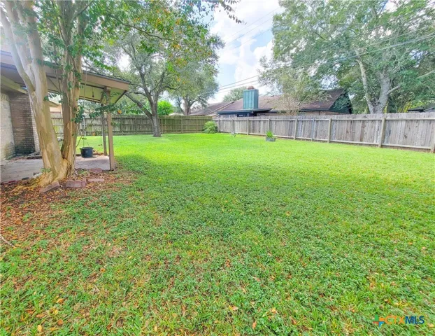 a view of a park with large trees