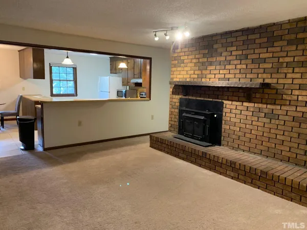 a view of an empty room with a fireplace