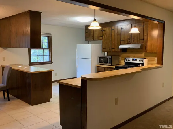 a kitchen with stainless steel appliances a refrigerator and a microwave