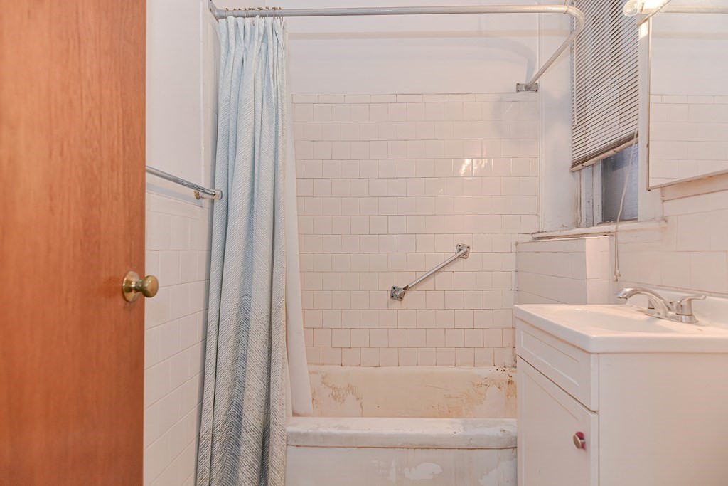22 Orkney Road, Unit 5 Boston, MA 02135 - Photo 11 of 42 a bathroom with a bathtub a sink and a shower
