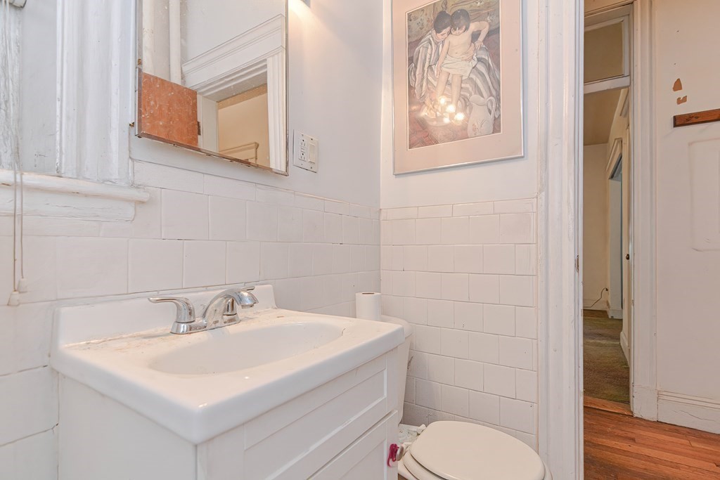 22 Orkney Road, Unit 5 Boston, MA 02135 - Photo 12 of 42 a bathroom with a toilet sink and mirror