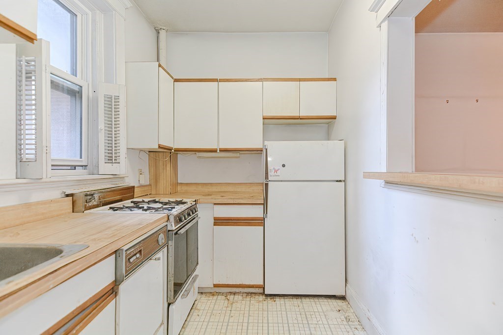 22 Orkney Road, Unit 5 Boston, MA 02135 - Photo 13 of 42 a kitchen with a refrigerator a stove a sink and a cabinets