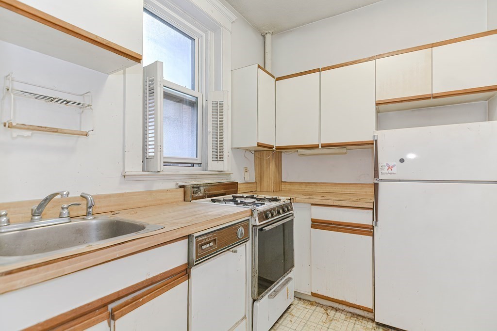 22 Orkney Road, Unit 5 Boston, MA 02135 - Photo 14 of 42 a kitchen with stainless steel appliances granite countertop a sink stove and cabinets