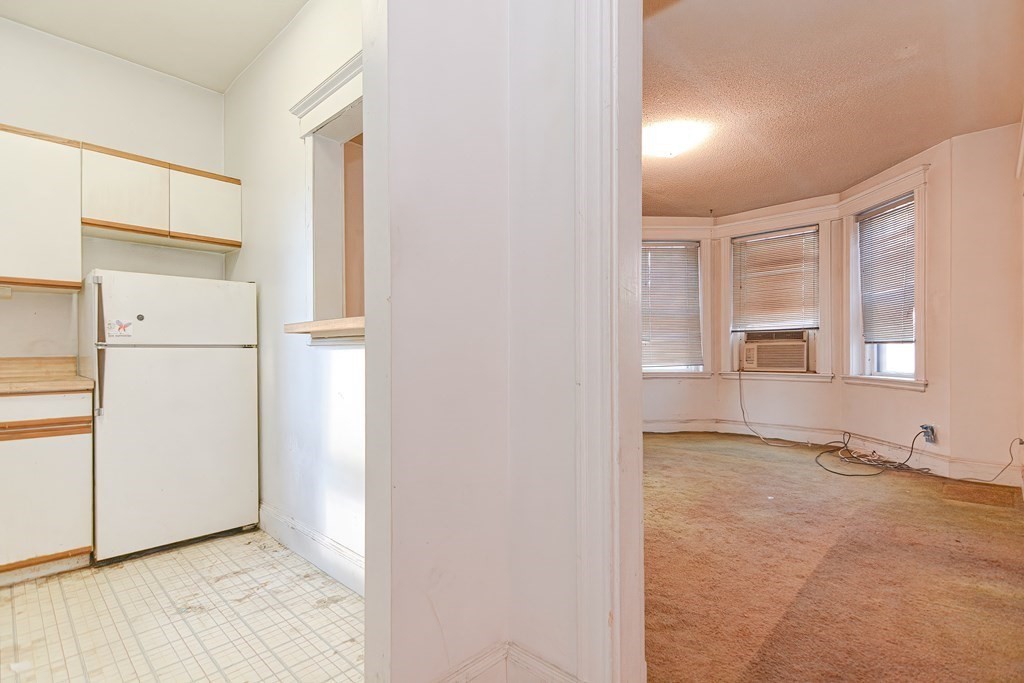 22 Orkney Road, Unit 5 Boston, MA 02135 - Photo 30 of 42 a view of a refrigerator in kitchen and white cabinets