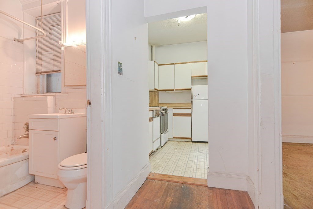 22 Orkney Road, Unit 5 Boston, MA 02135 - Photo 35 of 42 a bathroom with a toilet sink and a mirror