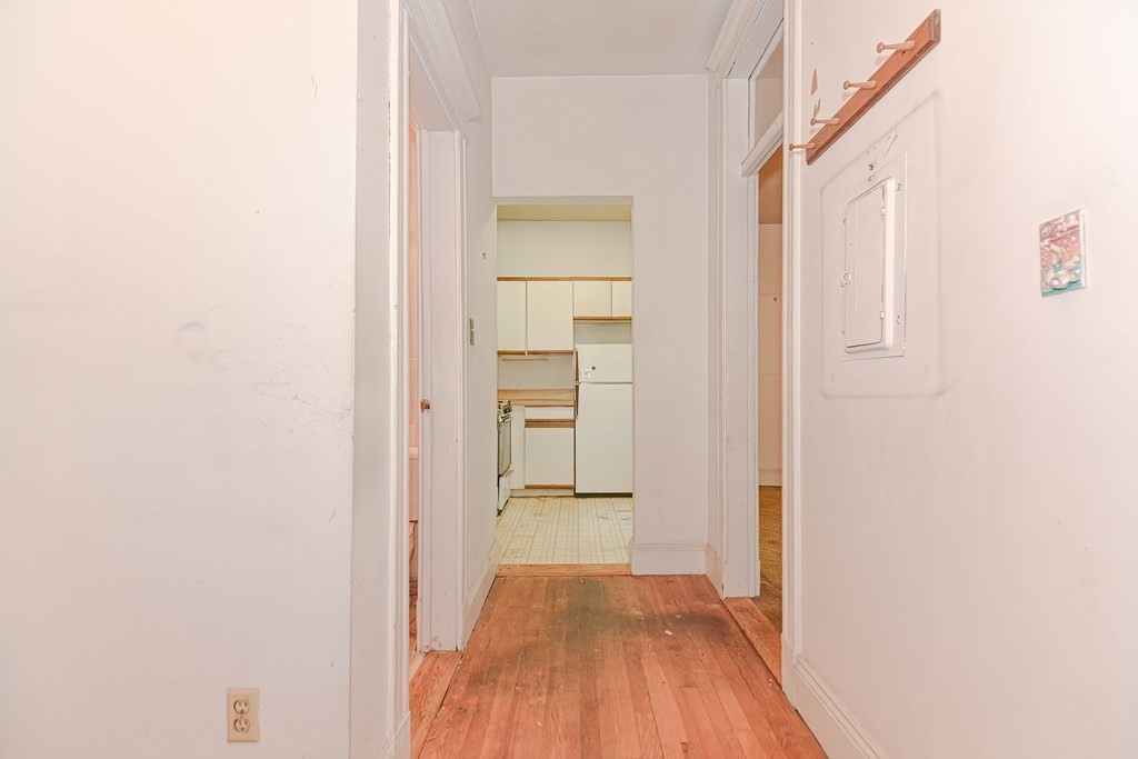 22 Orkney Road, Unit 5 Boston, MA 02135 - Photo 7 of 42 a view of a hallway with wooden floor and a bathroom