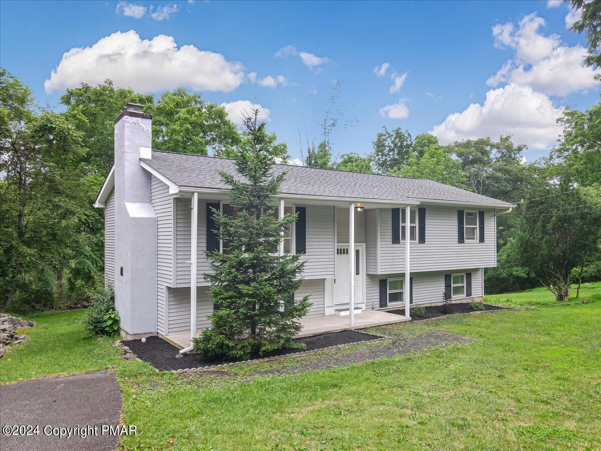 6051 Neola Road Stroudsburg, PA 18360 - Photo 2 of 57 a view of a house with a yard and potted plants