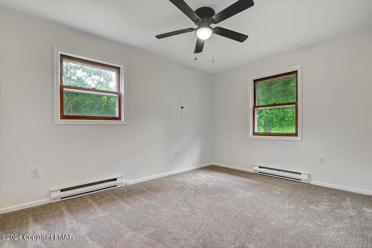 6051 Neola Road Stroudsburg, PA 18360 - Photo 24 of 57 an empty room with a window and a ceiling fan