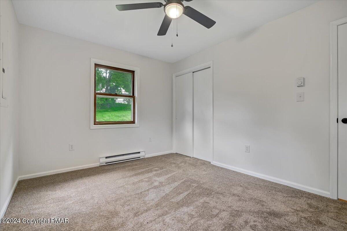 6051 Neola Road Stroudsburg, PA 18360 - Photo 25 of 57 an empty room with a window and a ceiling fan