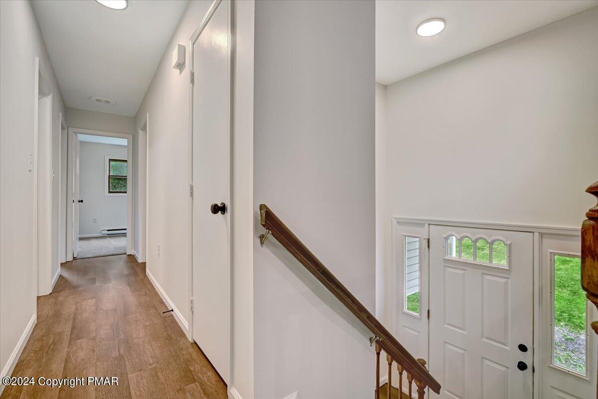 6051 Neola Road Stroudsburg, PA 18360 - Photo 32 of 57 a view of a hallway with wooden floor and staircase