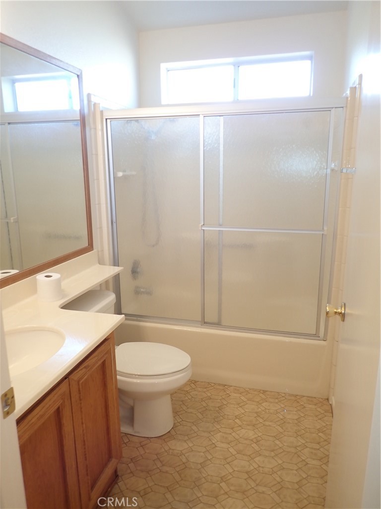 27250 Murrieta Road, Unit 332 Menifee, CA 92586 - Photo 16 of 26 a bathroom with a granite countertop sink toilet and shower