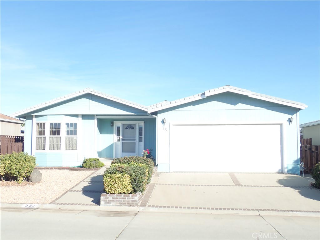 27250 Murrieta Road, Unit 332 Menifee, CA 92586 - Photo 2 of 26 a front view of a house with a yard and garage