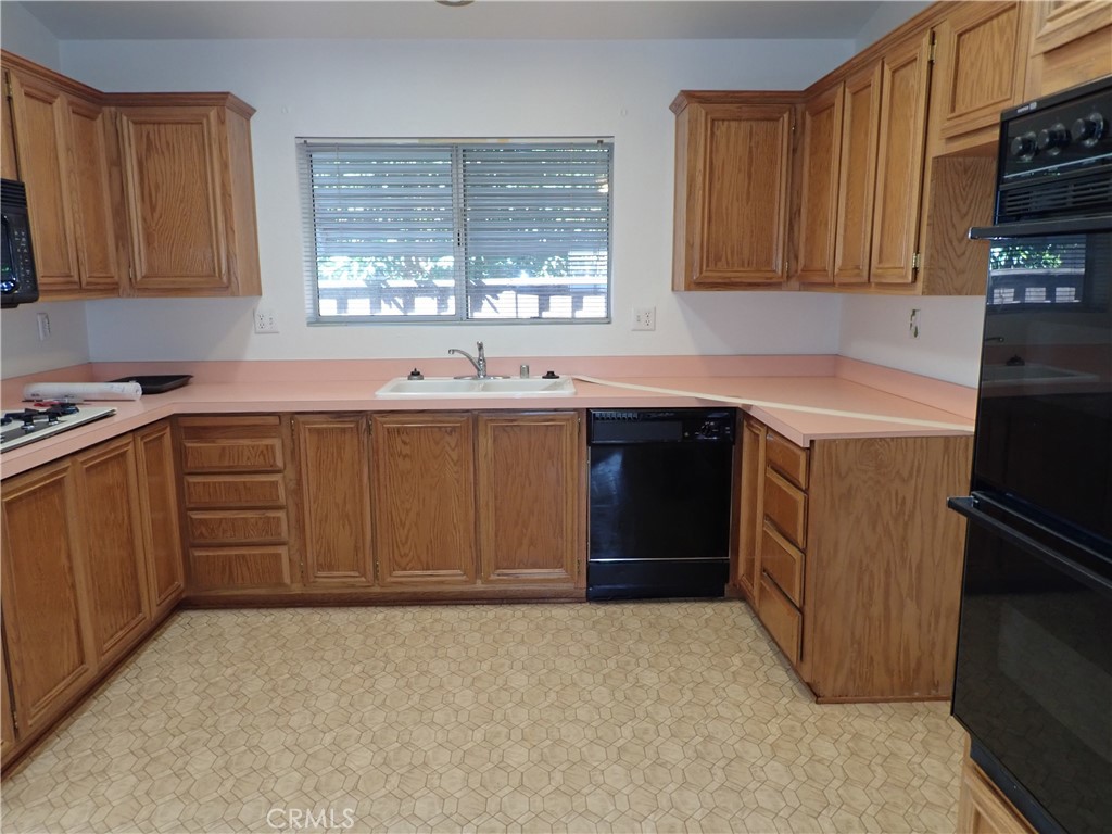 27250 Murrieta Road, Unit 332 Menifee, CA 92586 - Photo 10 of 26 a kitchen with a sink stove and cabinets