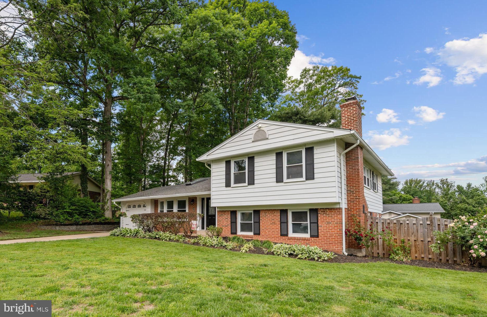 6800 Seton Court Springfield, VA 22152 - Photo 49 of 51 a front view of a house with a garden