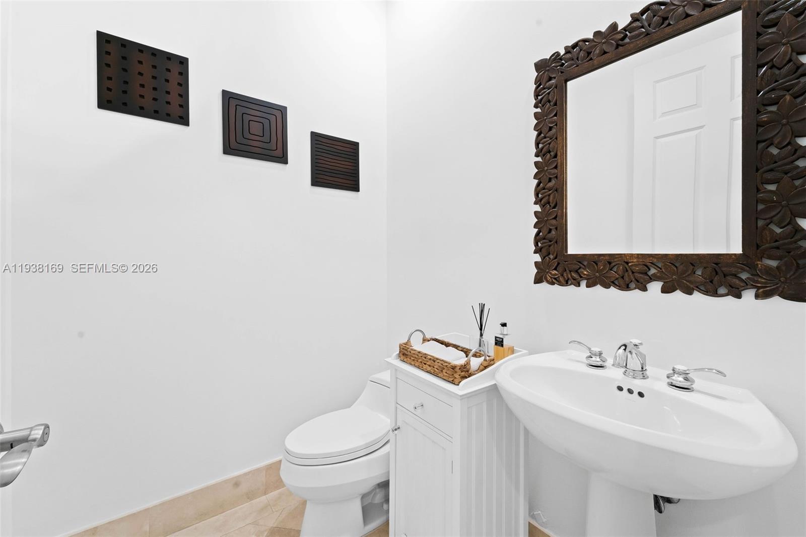 1490 Cleveland Road Miami Beach, FL 33141 - Photo 27 of 38 a bathroom with a sink toilet and mirror