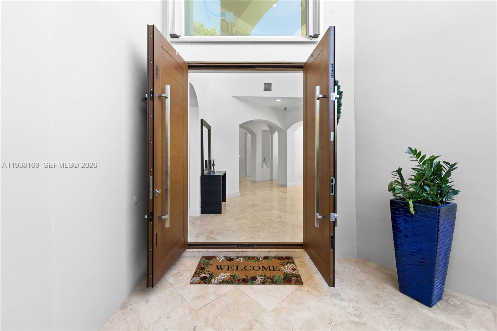1490 Cleveland Road Miami Beach, FL 33141 - Photo 4 of 38 a view of a hallway with wooden floor and a potted plant