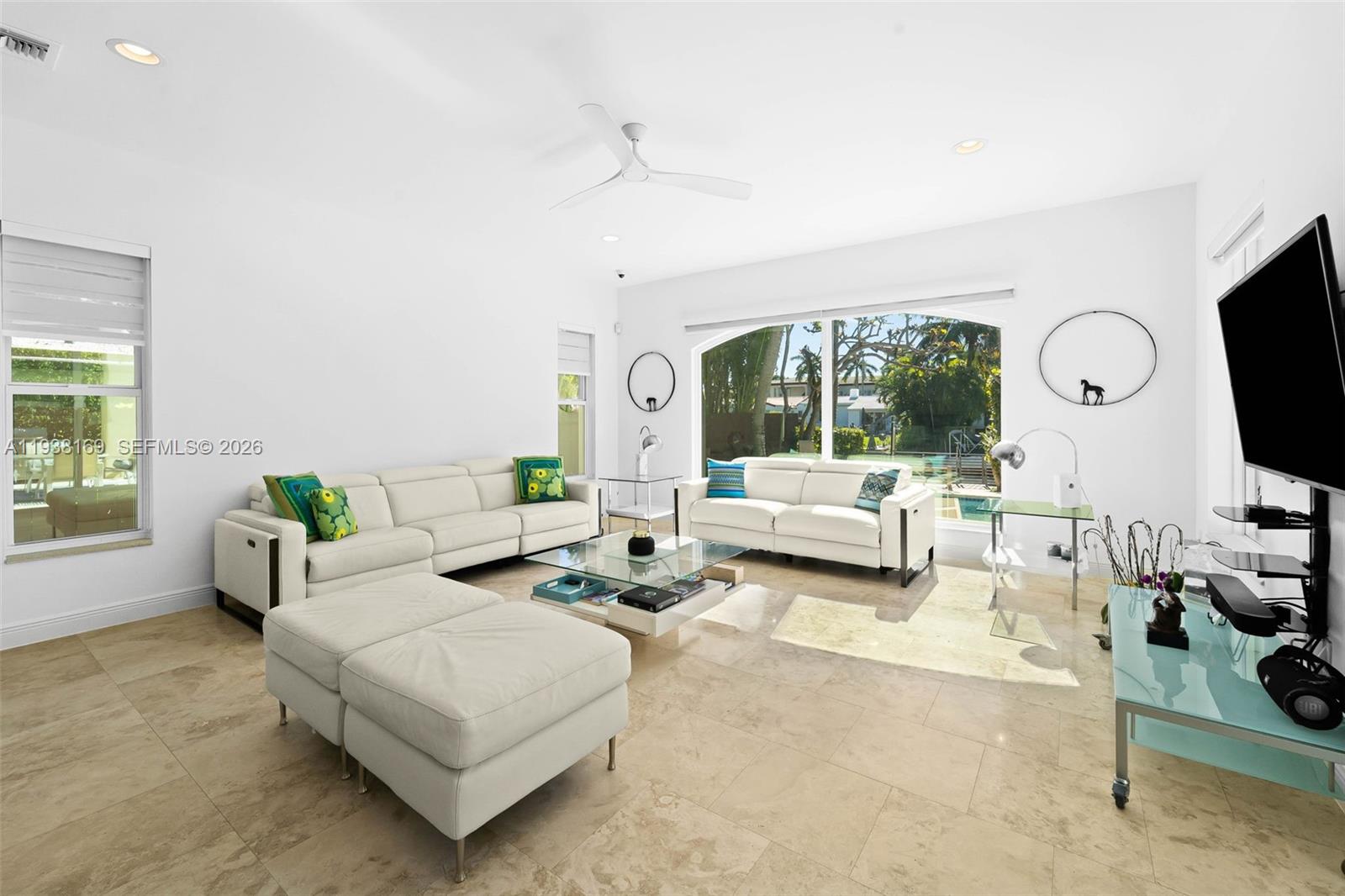 1490 Cleveland Road Miami Beach, FL 33141 - Photo 8 of 38 a living room with furniture a flat screen tv and a large window
