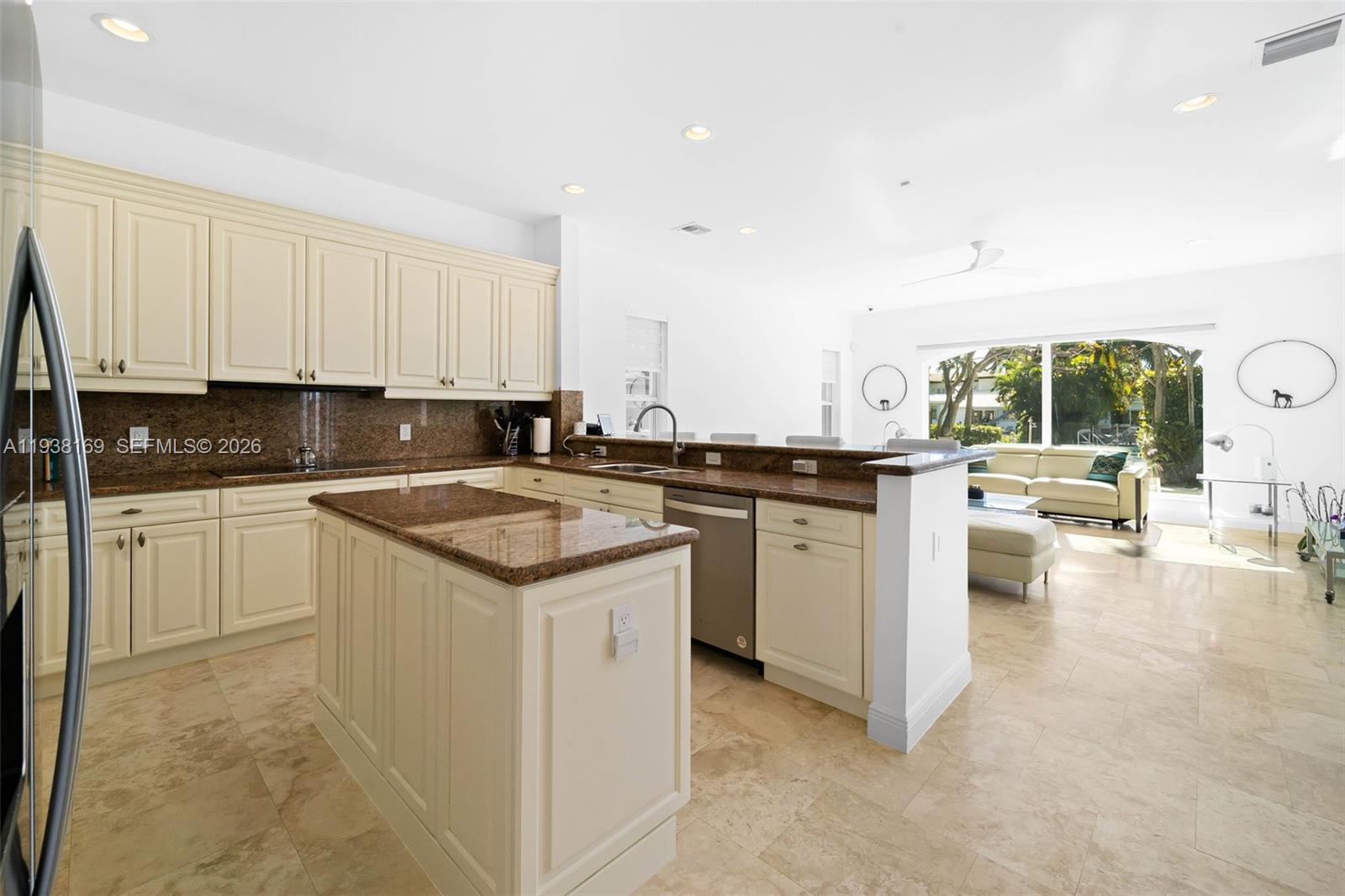 1490 Cleveland Road Miami Beach, FL 33141 - Photo 9 of 38 a kitchen with a sink stove and cabinets