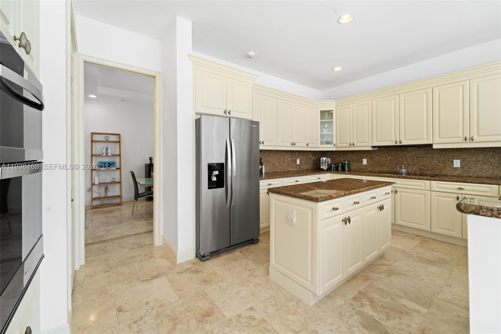 1490 Cleveland Road Miami Beach, FL 33141 - Photo 10 of 38 a kitchen with stainless steel appliances granite countertop a refrigerator and a stove