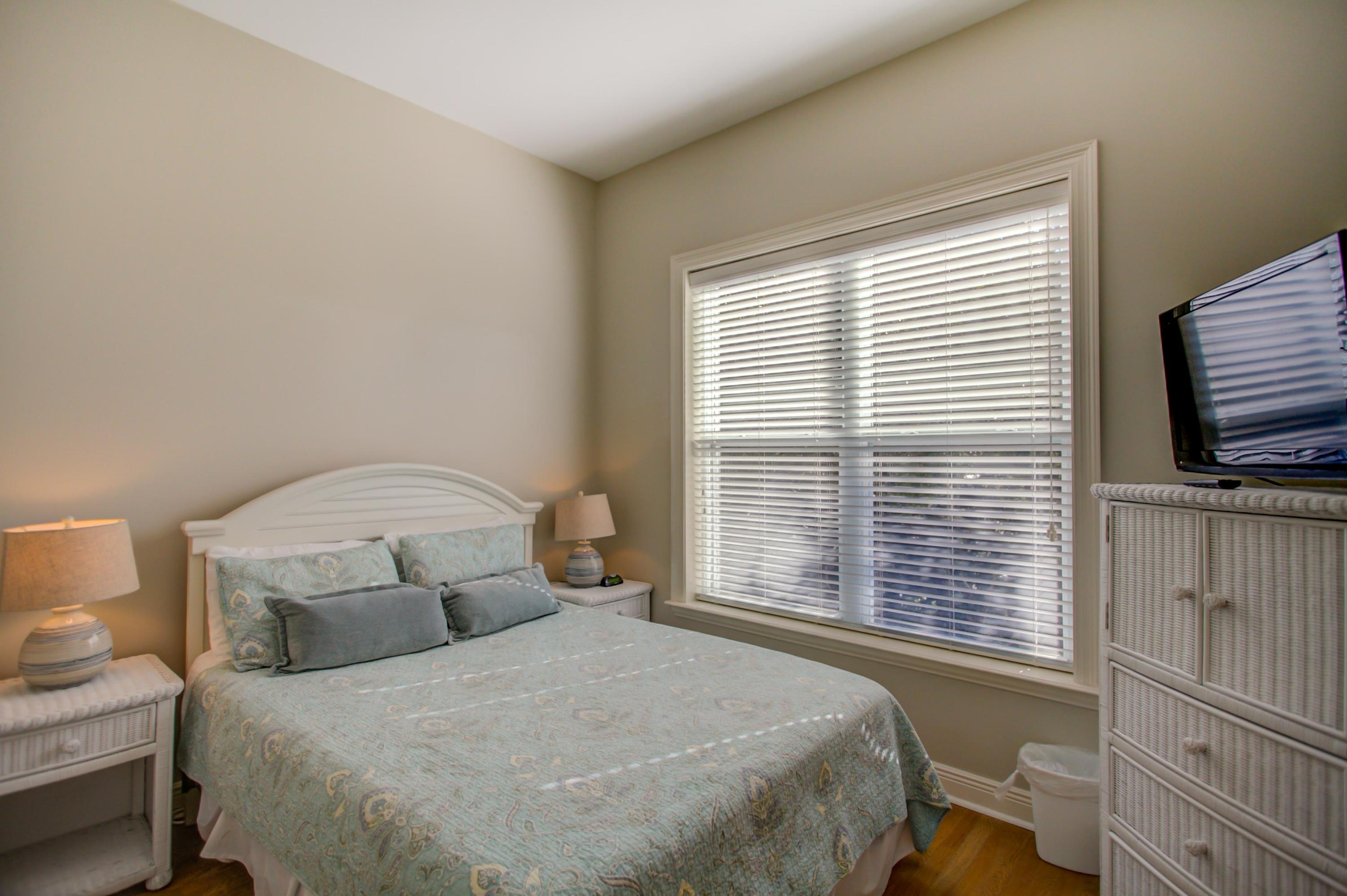 32 Hickory Street Santa Rosa Beach, FL 32459 - Photo 26 of 43 a bedroom with a bed and a flat tv screen on a dresser
