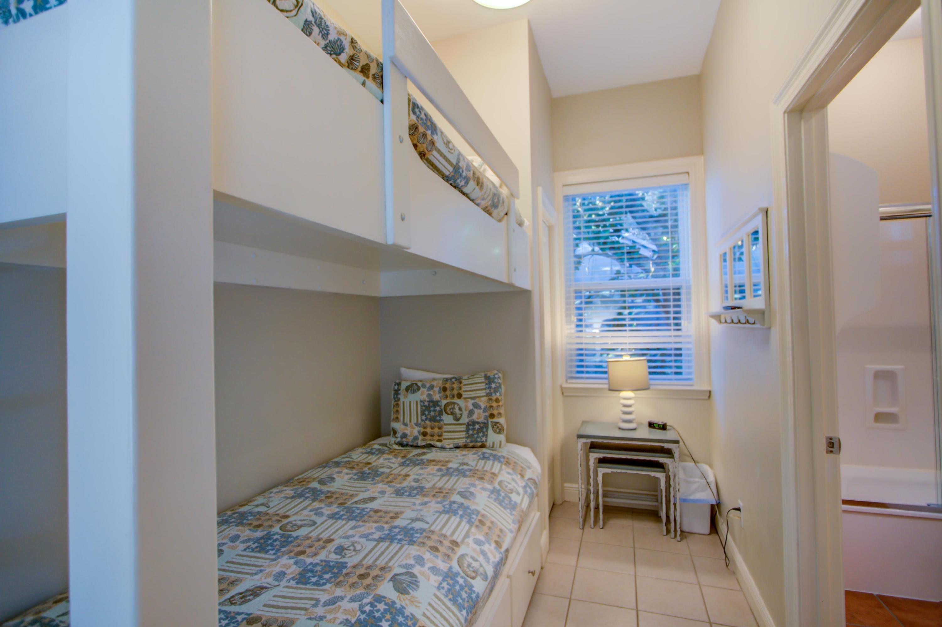 32 Hickory Street Santa Rosa Beach, FL 32459 - Photo 27 of 43 a bedroom with a bed and a table in it