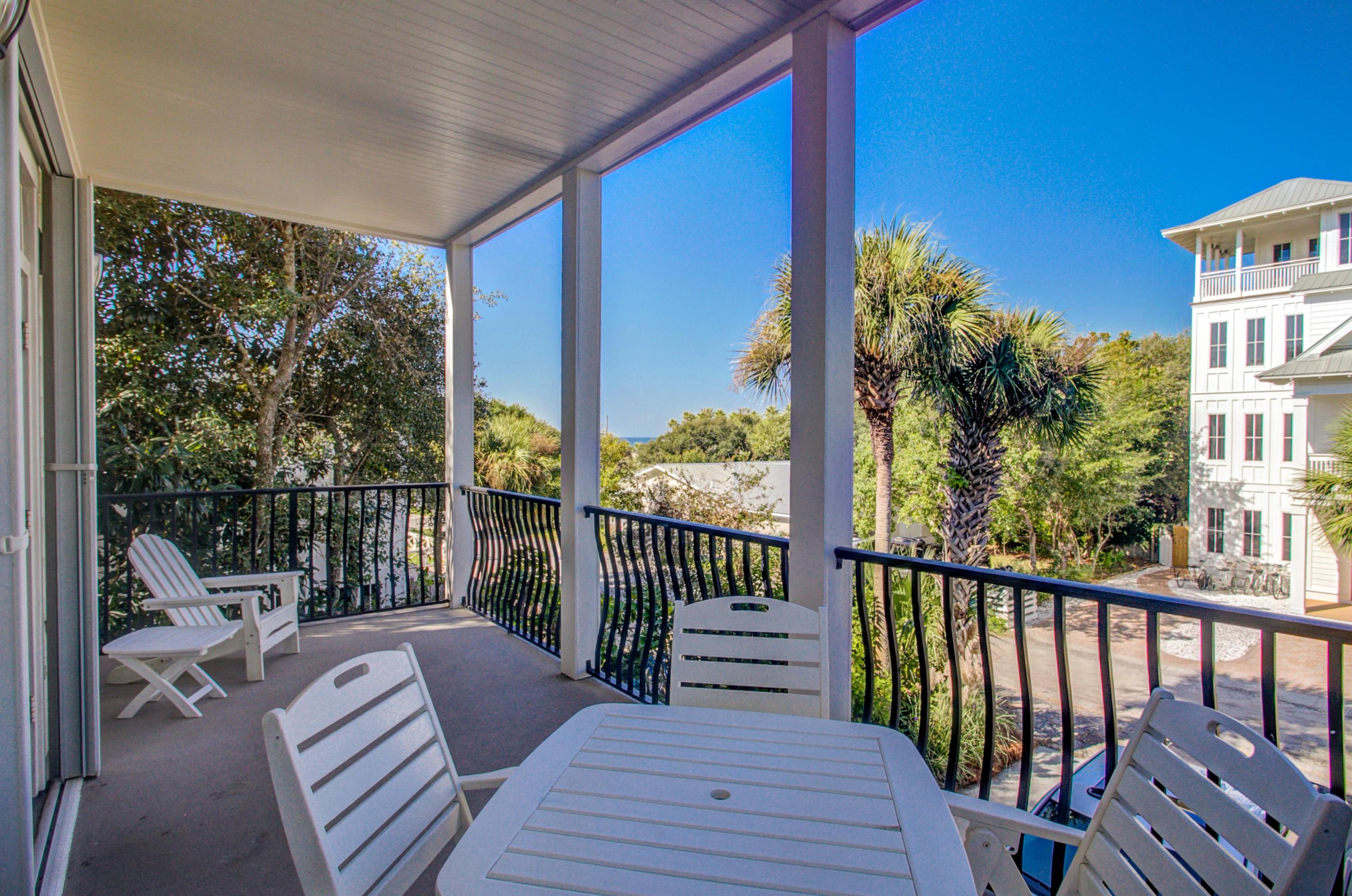 32 Hickory Street Santa Rosa Beach, FL 32459 - Photo 35 of 43 a balcony with wooden floor table and chairs