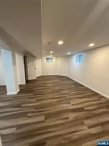 a view of a room with wooden floor