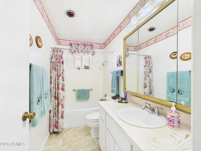a view of a dining room with furniture a chandelier and wooden floor