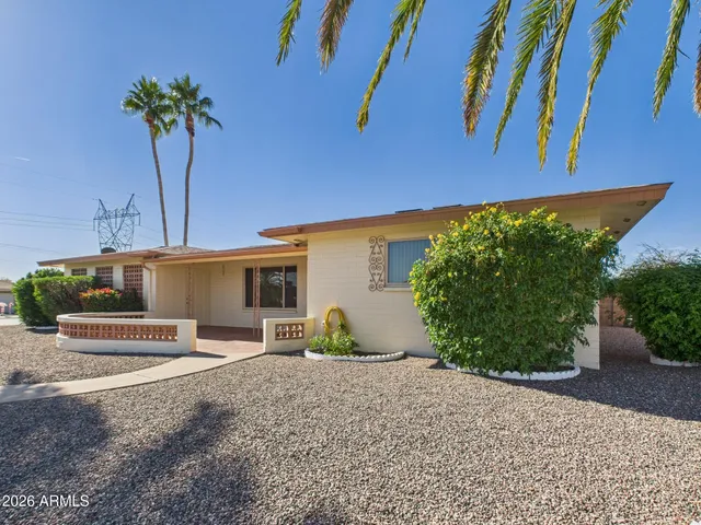a view of palm trees and a building