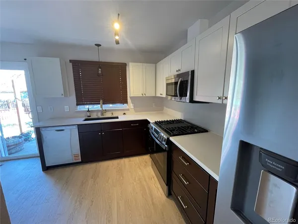 a kitchen with a stove and a refrigerator