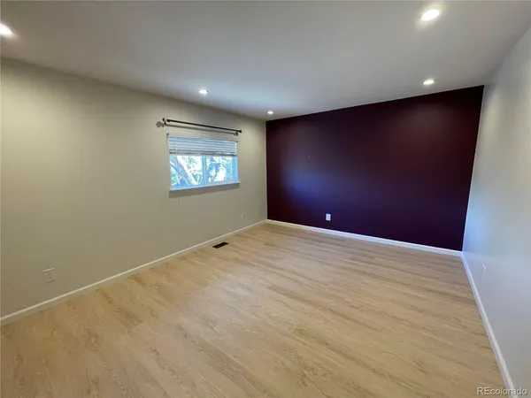 an empty room with windows and closet