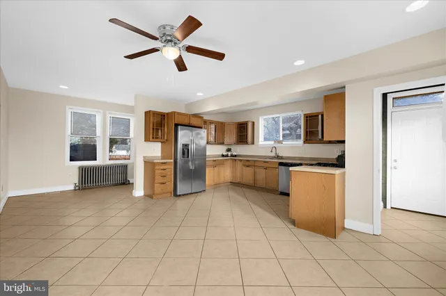 a kitchen with stainless steel appliances a refrigerator sink and cabinets