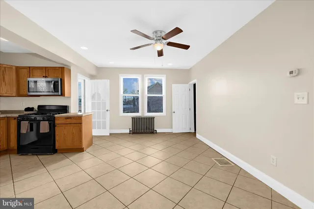 a view of a kitchen with furniture and white walls