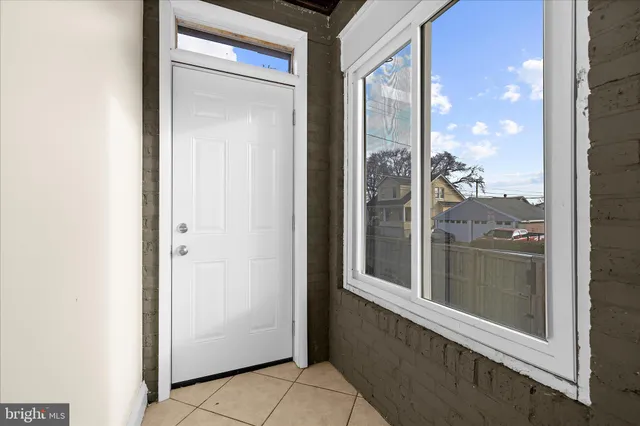a view of a livingroom with wooden floor and staircase
