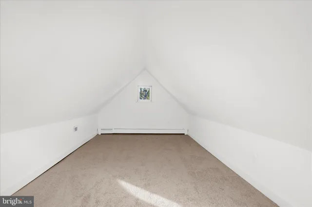 an empty room with ceiling fan and windows