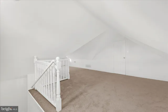 a bathroom with a sink mirror and a toilet