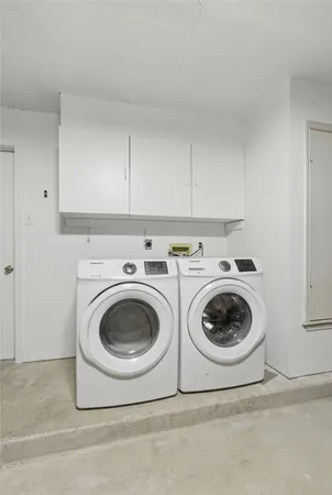 a utility room with sink dryer and washer