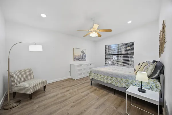 a bedroom with a bed and wooden floor
