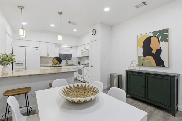 a kitchen with a table and chairs in it
