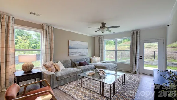 a living room with furniture and a large window