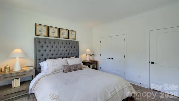 a bedroom with bed and a night stand