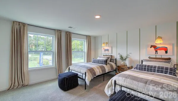a bedroom with two beds and a window