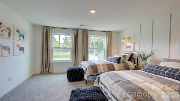 a bedroom with two beds and a large window