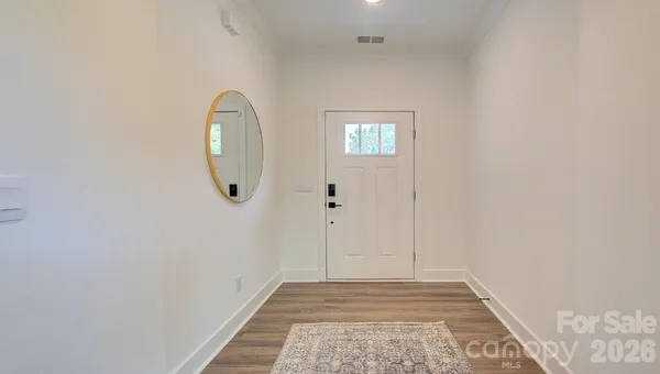 a view of a livingroom with wooden floor and a carpet