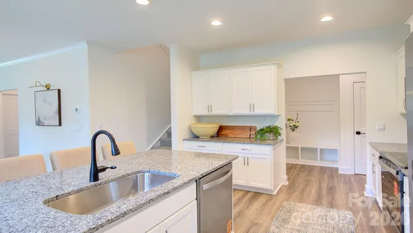 a kitchen with a sink and a refrigerator
