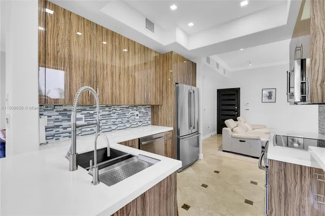 a kitchen with stainless steel appliances a refrigerator and a sink