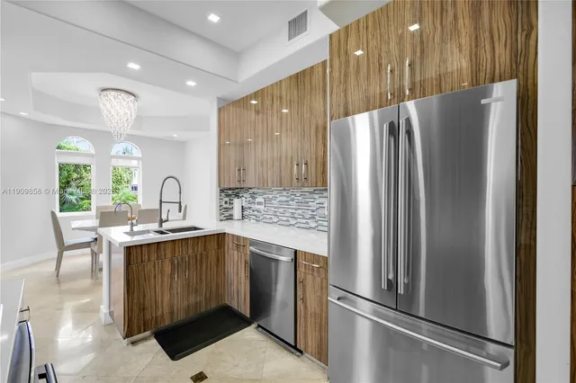 a kitchen with kitchen island granite countertop a sink and a stove