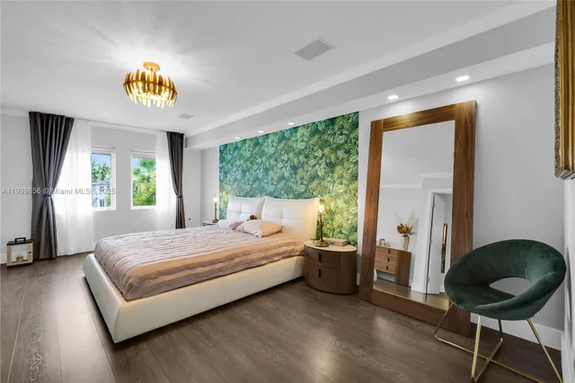 a bedroom with a bed and a chandelier