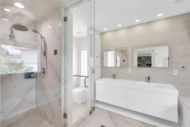 a bathroom with a sink a toilet and mirror